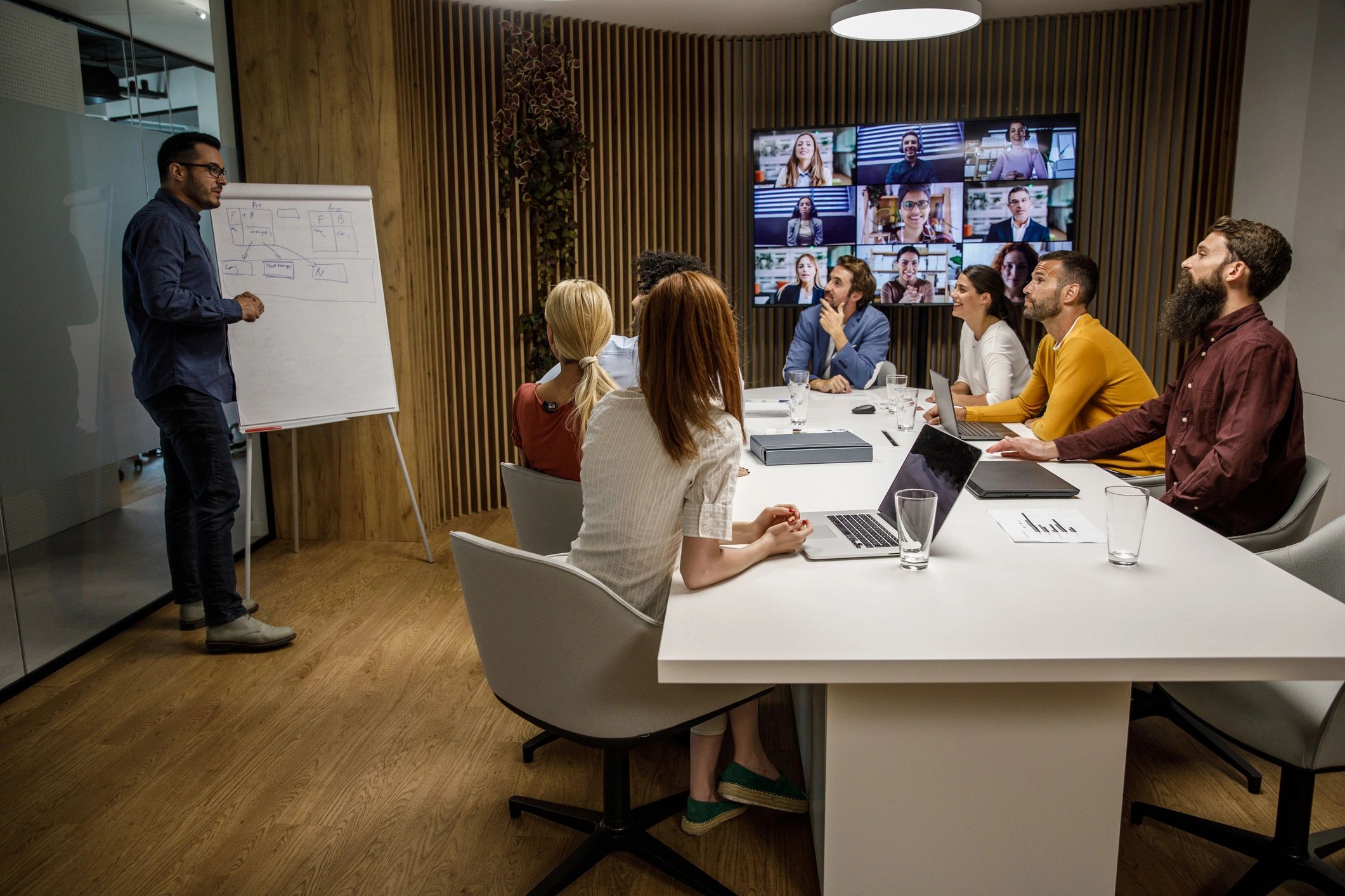 Executive presenting a strategy to a leadership team in a boardroom